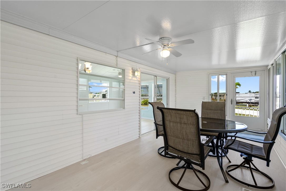 19681 Summerlin Road, Unit 234 Fort Myers, FL 33908 - Photo 9 of 41 a view of a dining room with furniture and wooden floor