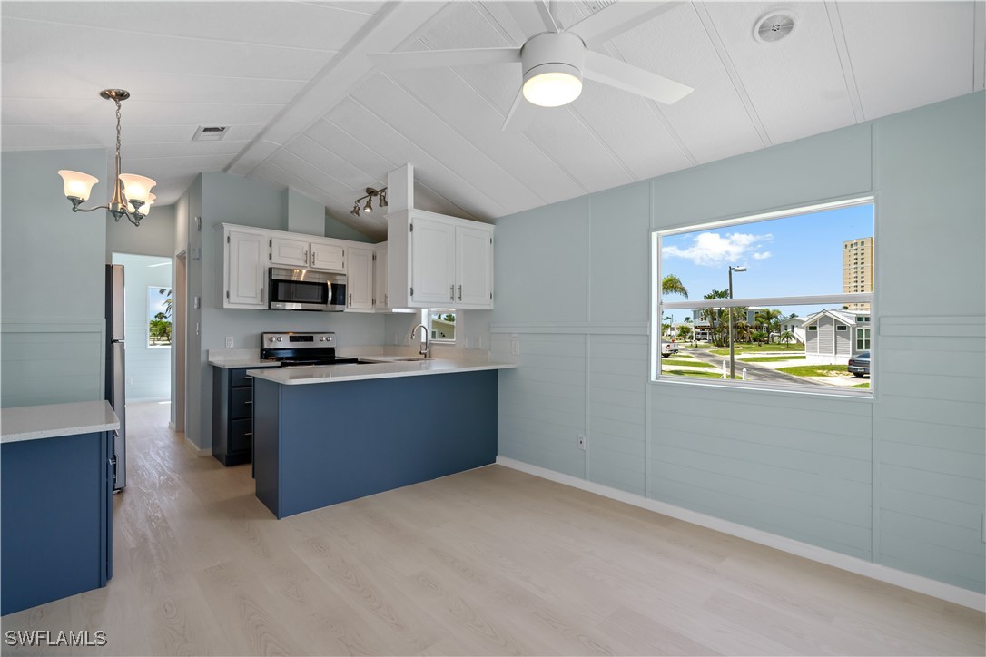 19681 Summerlin Road, Unit 234 Fort Myers, FL 33908 - Photo 10 of 41 a kitchen with kitchen island a counter space a sink and appliances