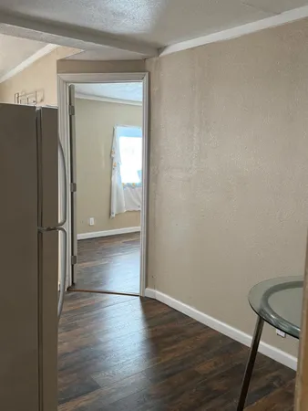 a view of a room with wooden floor and a window