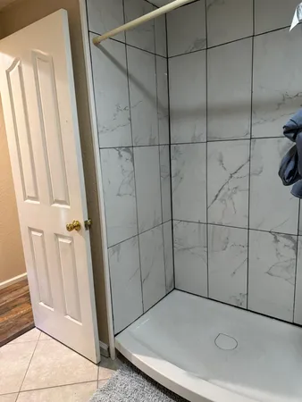 a bathroom with a glass door shower