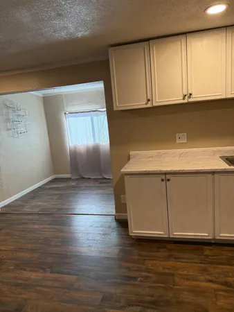 a view of cabinets and wooden floor