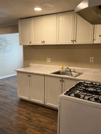 a kitchen with wooden cabinets and a stove top oven