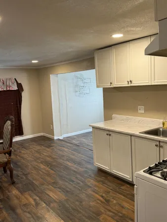 a view of kitchen with wooden floor and electronic appliances