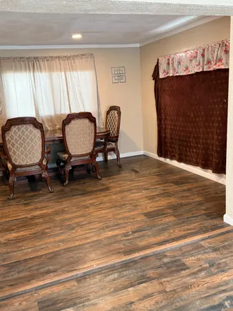 a living room with furniture a window and a fireplace