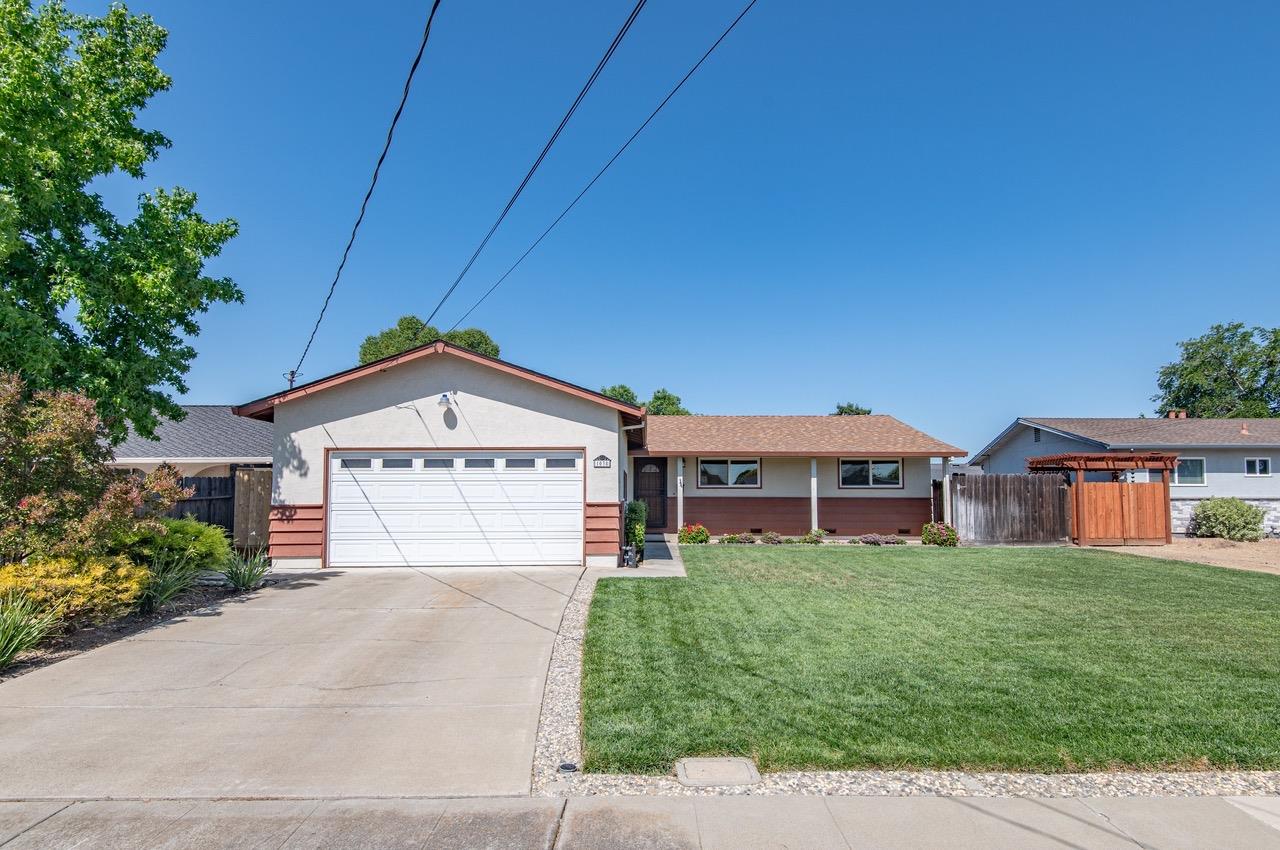 1038 Apache Street Livermore, CA 94551 - Photo 1 of 1 a view of a white house next to a yard with potted plants