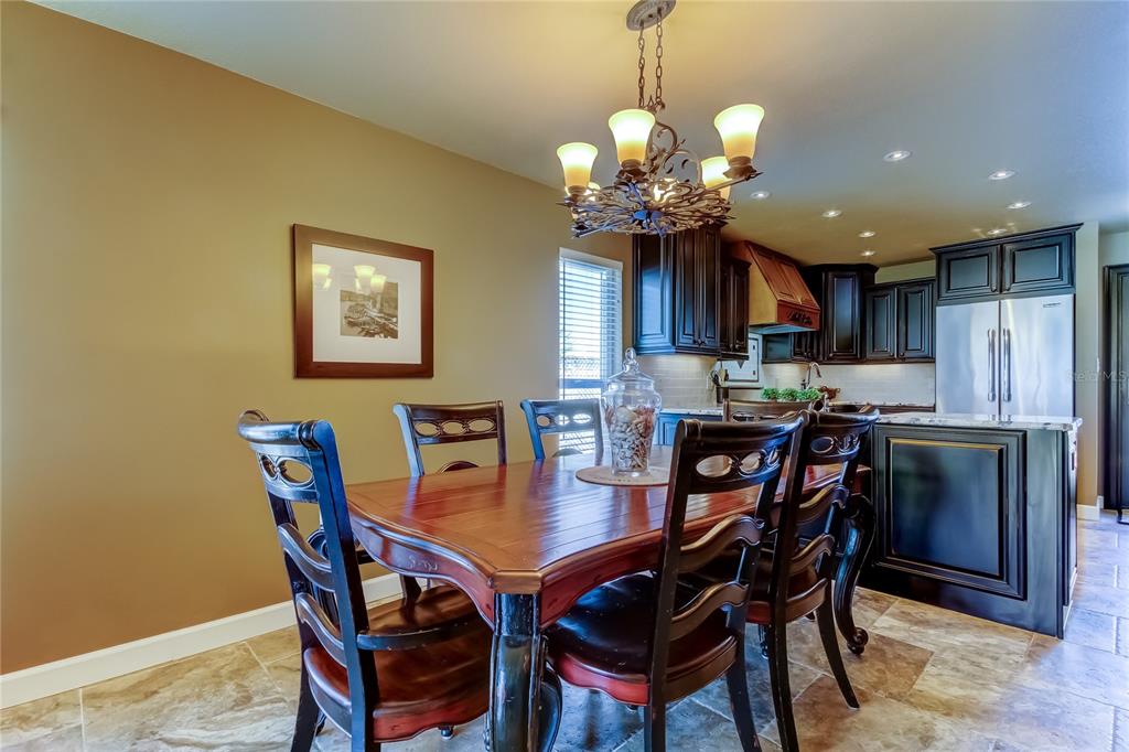 7003 Sunset Way, Unit 1 St. Pete Beach, FL 33706 - Photo 17 of 70 a view of a dining room with furniture and chandelier