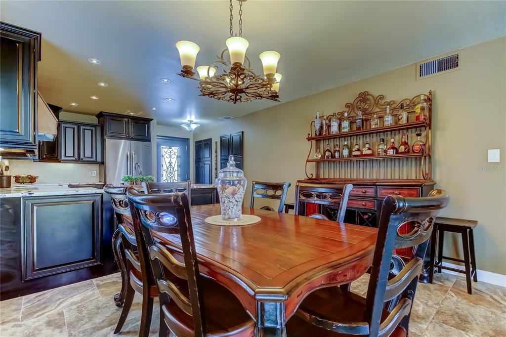 7003 Sunset Way, Unit 1 St. Pete Beach, FL 33706 - Photo 18 of 70 a view of a dining room with furniture and chandelier