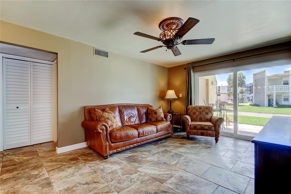 7003 Sunset Way, Unit 1 St. Pete Beach, FL 33706 - Photo 21 of 70 a living room with furniture and a large window