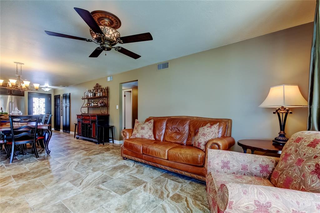 7003 Sunset Way, Unit 1 St. Pete Beach, FL 33706 - Photo 22 of 70 a living room with furniture and a fireplace