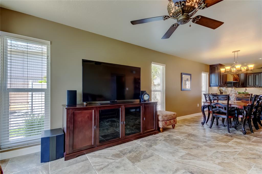 7003 Sunset Way, Unit 1 St. Pete Beach, FL 33706 - Photo 23 of 70 a view of a livingroom with furniture and a flat screen tv