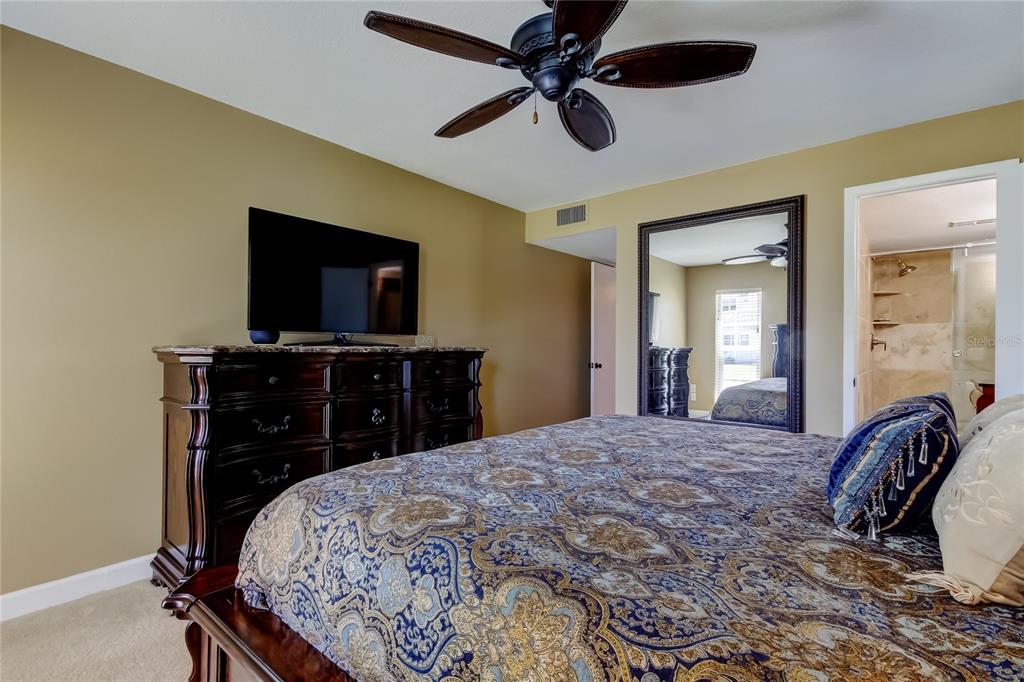 7003 Sunset Way, Unit 1 St. Pete Beach, FL 33706 - Photo 30 of 70 a bed room with a bed and a television