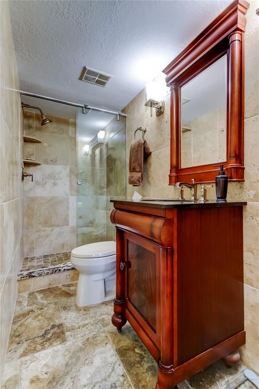 7003 Sunset Way, Unit 1 St. Pete Beach, FL 33706 - Photo 32 of 70 a bathroom with a toilet a sink and mirror