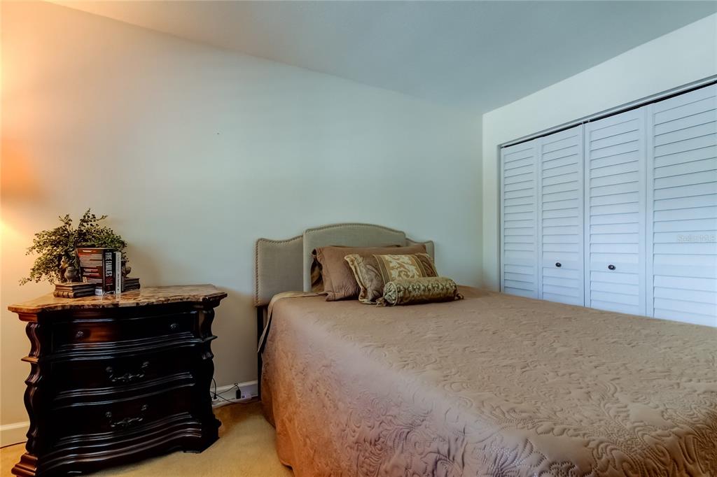 7003 Sunset Way, Unit 1 St. Pete Beach, FL 33706 - Photo 35 of 70 a bedroom with a bed and a dresser