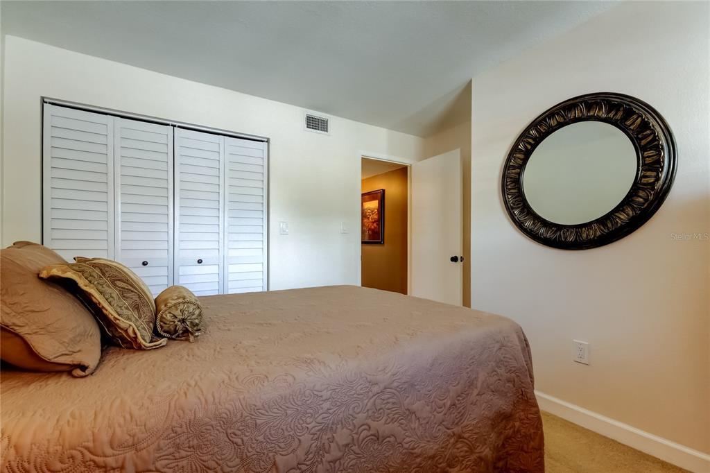 7003 Sunset Way, Unit 1 St. Pete Beach, FL 33706 - Photo 36 of 70 a bedroom with a bed and a window
