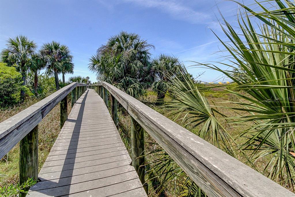 7003 Sunset Way, Unit 1 St. Pete Beach, FL 33706 - Photo 51 of 70 a view of balcony and wooden floor