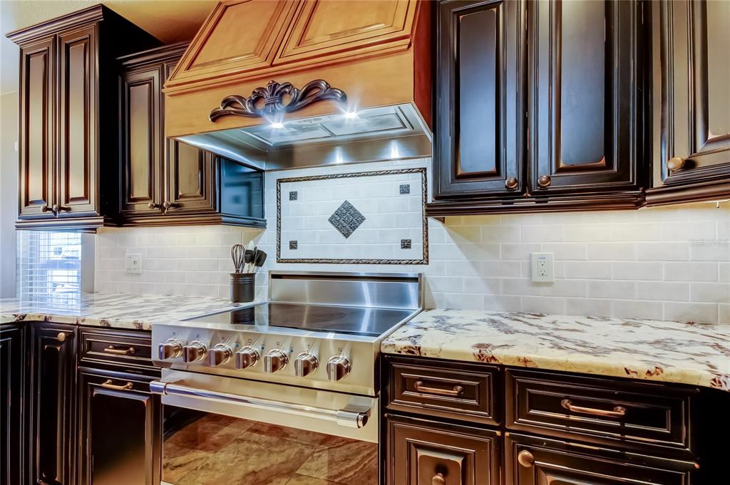 7003 Sunset Way, Unit 1 St. Pete Beach, FL 33706 - Photo 9 of 70 a kitchen with a stove and a microwave