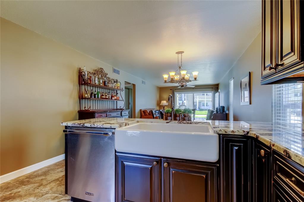 7003 Sunset Way, Unit 1 St. Pete Beach, FL 33706 - Photo 10 of 70 a kitchen with a stove and a refrigerator