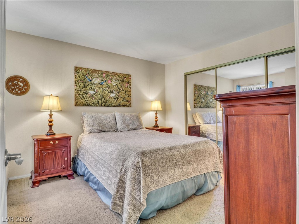3145 East Flamingo Road, Unit 2129 Las Vegas, NV 89121 - Photo 21 of 43 Plush carpeted floors and mirrored closet doors define this cozy bedroom retreat.