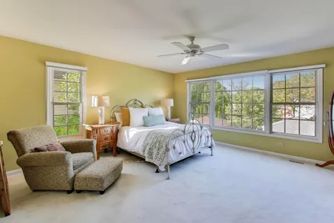 a spacious bathroom with a tub sink and mirror