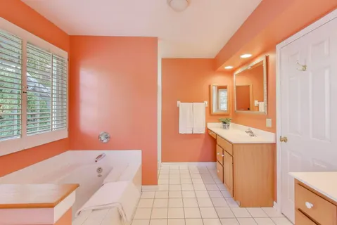 a spacious bedroom with a bed and window