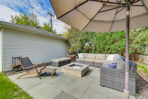 a backyard of a house with table and chairs