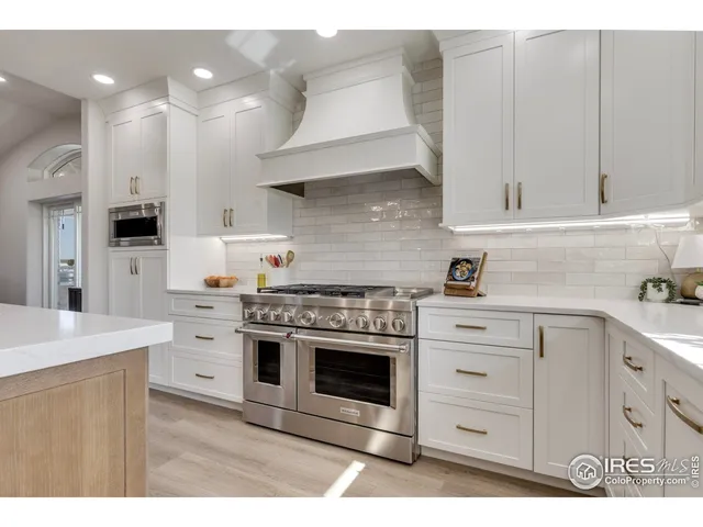 a kitchen with cabinets and white stainless steel appliances