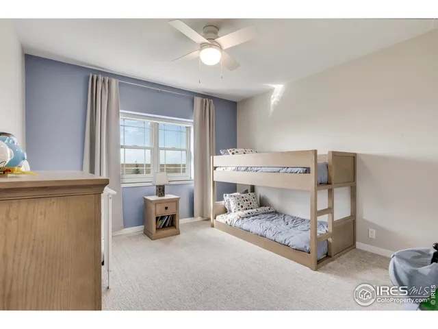 a bedroom with furniture and a large window