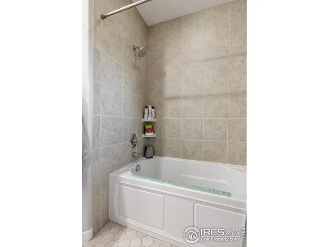 a white bath tub sitting next to a white sink