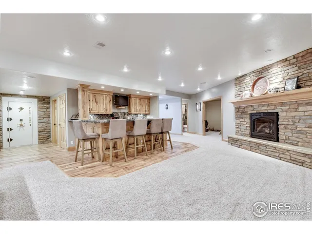 a living room with furniture a table and kitchen view