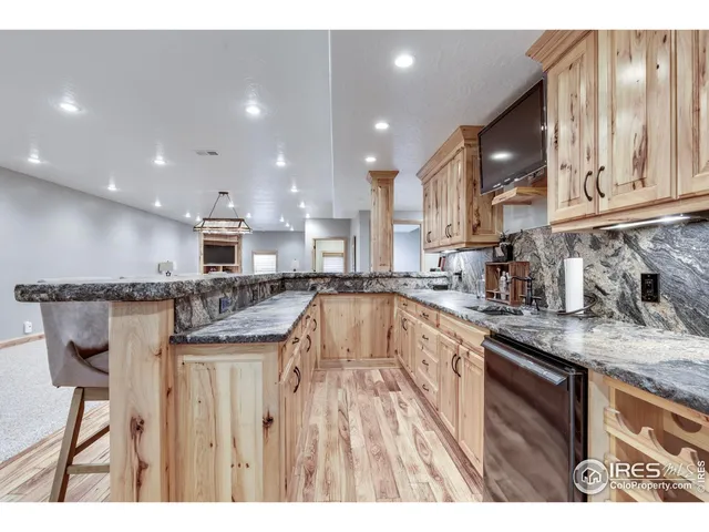 a kitchen with stainless steel appliances granite countertop a sink and cabinets