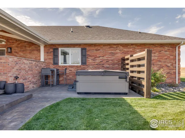 a view of an house with backyard space and a tub