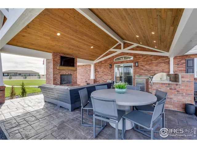 a view of a patio with a table and chairs