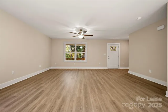 wooden floor in an empty room with a window