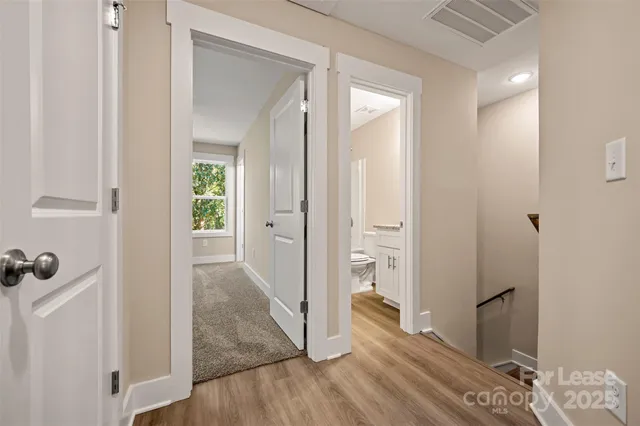 a bathroom with a granite countertop sink toilet a shower and a mirror