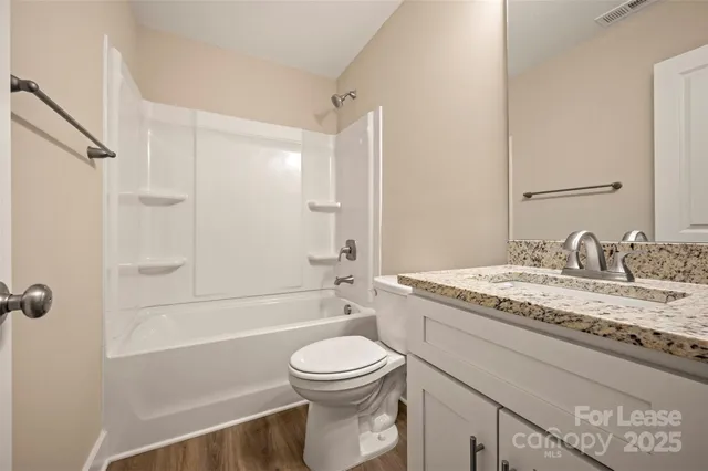 an empty room with window and ceiling fan