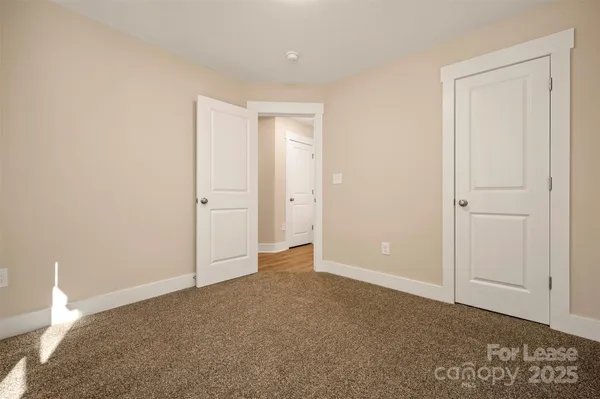 a view of a backyard with chairs and wooden fence