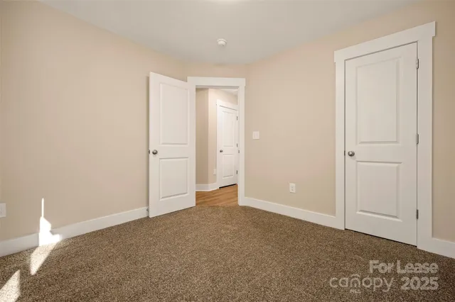 a view of a backyard with chairs and wooden fence