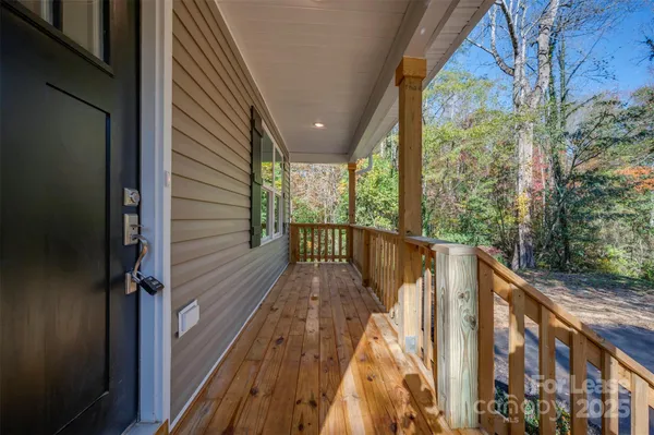 a view of balcony with wooden floor and fence