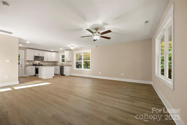 a view of a kitchen with a stove cabinets and a kitchen