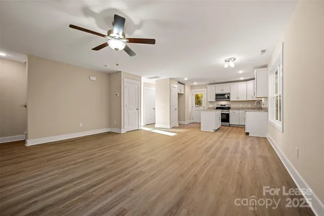 a view of a kitchen with a sink and a refrigerator