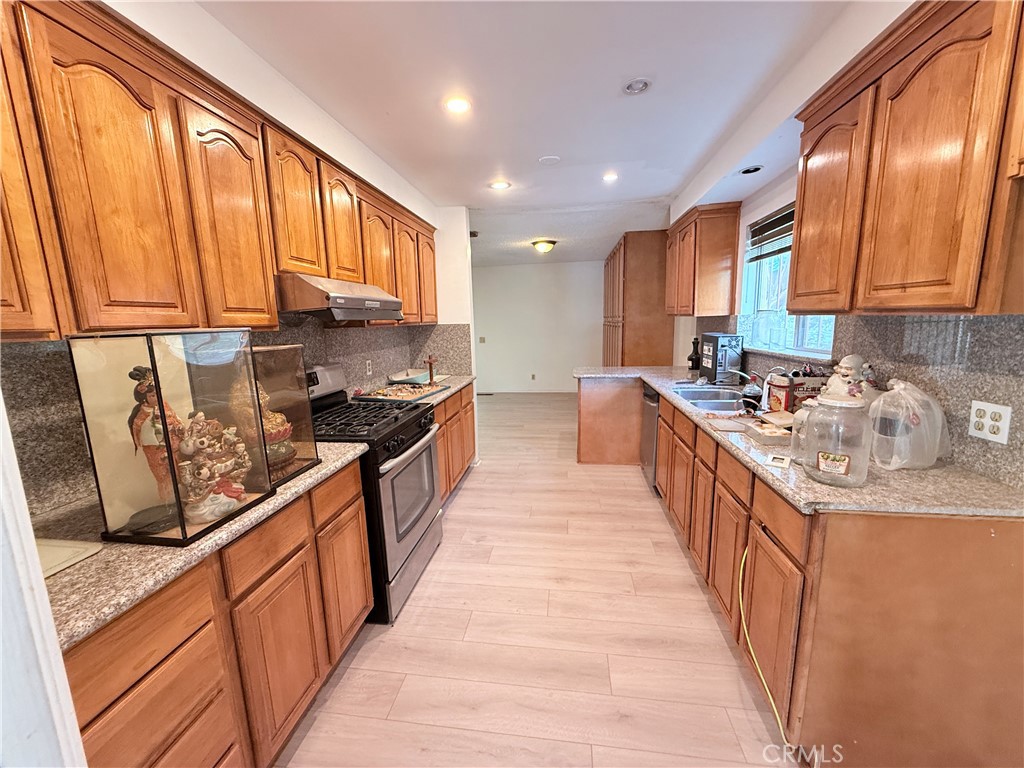 2575 Riverside Terrace Los Angeles, CA 90039 - Photo 6 of 29 a kitchen with stainless steel appliances granite countertop a stove a sink and a microwave