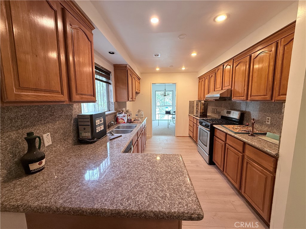 2575 Riverside Terrace Los Angeles, CA 90039 - Photo 7 of 29 a kitchen with stainless steel appliances granite countertop a stove top oven a sink and dishwasher