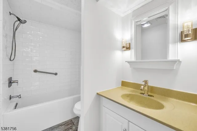 a view of a street with a large tree