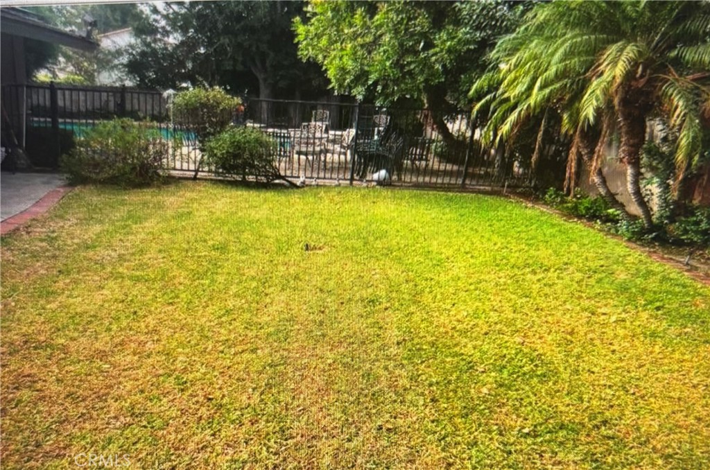 1920 Lorain Road San Marino, CA 91108 - Photo 24 of 32 a view of a swimming pool with a patio and a garden