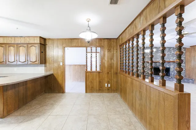 a large kitchen with a large counter top appliances and cabinets