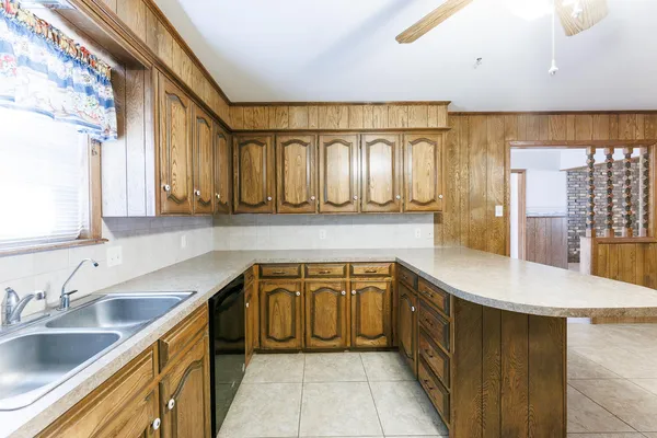 a kitchen with stainless steel appliances granite countertop a sink and cabinets