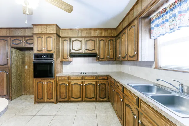 a kitchen with granite countertop and white cabinets