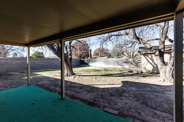 a view of a yard with snow on the road