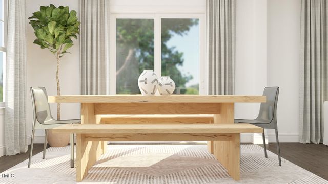 a view of dining room with furniture and a potted plant