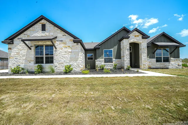 a front view of house with yard and green space